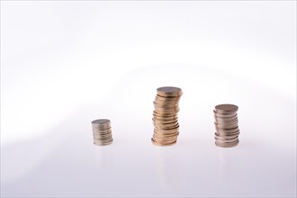 Turkish Lira coins on three piles on white background