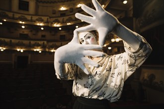 Female mime making hand frame