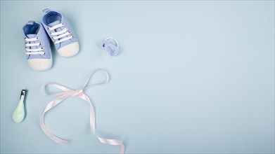 Ribbon with baby shoes copy space