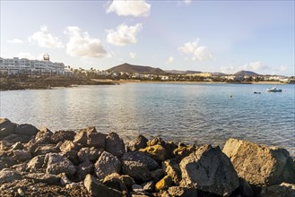 View of the resort town named Costa Teguise with boats on the foreground