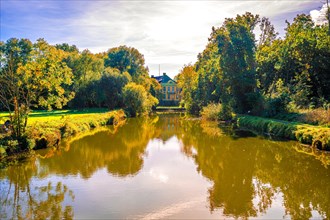 Hagenburg Canal with view to Hagenburg Castle in autumn with blue sky and sunshine