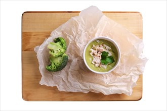 Top view of plate with broccoli cream soup with chicken isolated on white