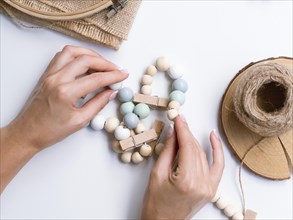 Woman making decorations with wood beads. Resolution and high quality beautiful photo