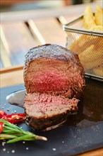 Grilled big fillet mignon beef steak cut on half