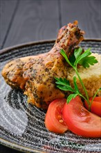Close up view of fried chicken leg with millet porridge