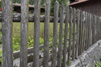 Wooden fence in front of a farmer's garden