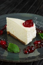 Closeup view of cheese cake decorated with cherry