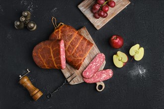 Homemade smoked beef sausage in organic casing on wooden cutting board