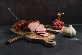 Air dried pork ham on wooden cutting board