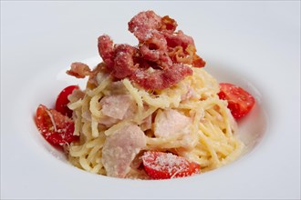 Plate with pasta served with bacon and ham