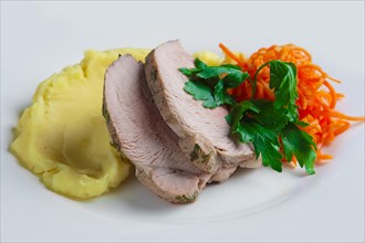 Plate with oven made pork with mashed potato and spicy carrot