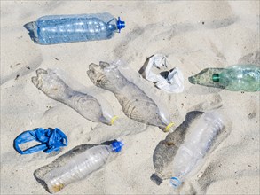 Empty plastic water bottles plastic bag sand