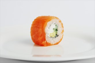 Smoked salmon roll with cheese on white background