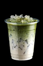 Iced matcha tea and crushed ice in take away cup isolated on black background