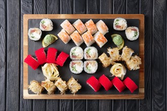 Big set of rolls served on stone plate. Layout for menu