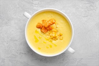 Top view of mashed corn soup puree with croutons