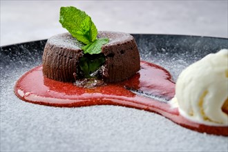 Closeup view of classic chocolate fondant with ice cream on a plate