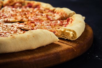 Close up view of cheese pizza cut in slices