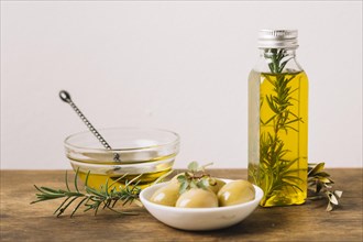 Olive oil bottle with rosemary olives