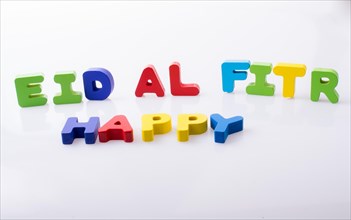 The word EID EL FITR written with colorful letter blocks