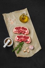 Overhead view of raw fresh lamb double loin chop on wrapping paper