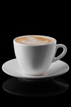Big ceramic cup of cappuccino isolated on black background