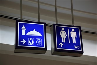 Signs for mosque and toilets in the City Centre Doha