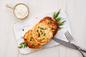 Top view of potato pancakes stuffed with chopped salmon meat