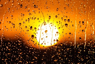 Raindrops on the glass during sunset