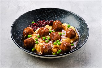 Meatballs with gravy served with mashed potato