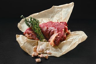 Raw beef neck with garlic packed in wrapping paper
