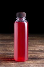 Small bottle of cranberry juice. Natural fruit-drink