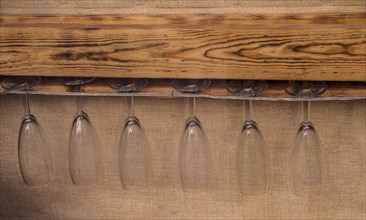 Glass cups hanging from a wooden platform in the view