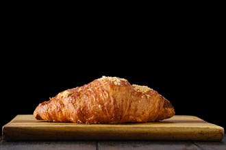 Classic croissant on wooden serving board