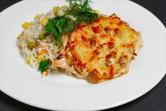 Baked meat with mushrooms and cheese with rice and sweet corn