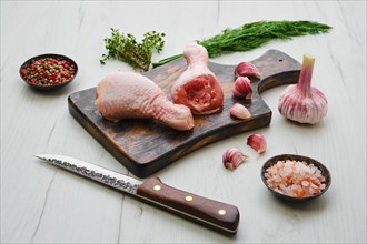 Raw chicken legs on wooden cutting board ready for cooking