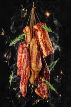 Composition of assortment of air dried and smoked lamb and beef meat on hanger