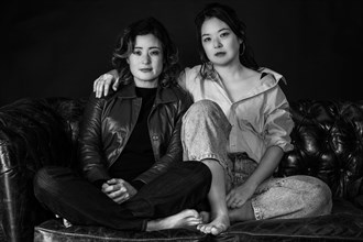 Two Asian woman on couch