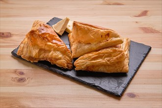 Puff pastry with cheese on slate plate