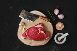 Overhead view of raw top round roast beef steak on wooden cutting board