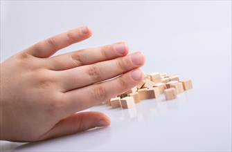 Hand playing with wooden cubes as educational and business concept