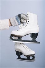 Woman holding white skates hand. Resolution and high quality beautiful photo