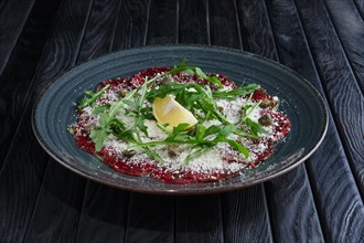 Beef carpaccio with grated cheese