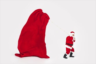 Santa claus dragging giant new year bag