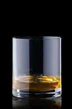 Portion of bourbon in transperent glass isolated on black background