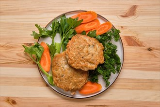Fried beef cutlet in breading with fresh carrot