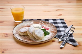 Traditional breakfast with cottage cheese pancake with sour cream