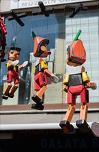 Wooden pinocchio dolls with long nose. Conceptual fairy tale character