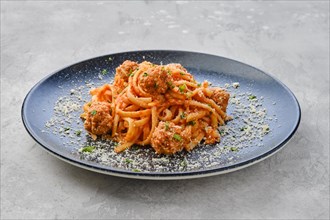 Spaghetti pasta with meatballs and grated cheese