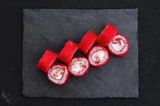 Rolls with shrimp and flying fish roe on slate plate